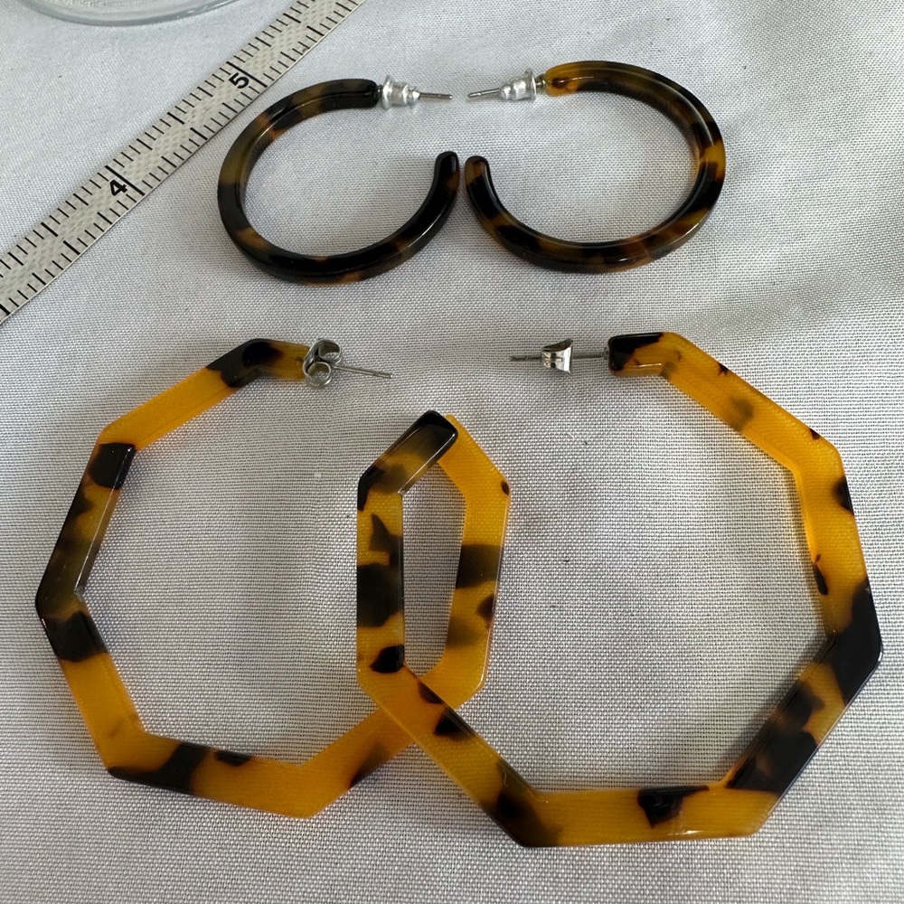 Two pair of tortoise colored open hoop earrings